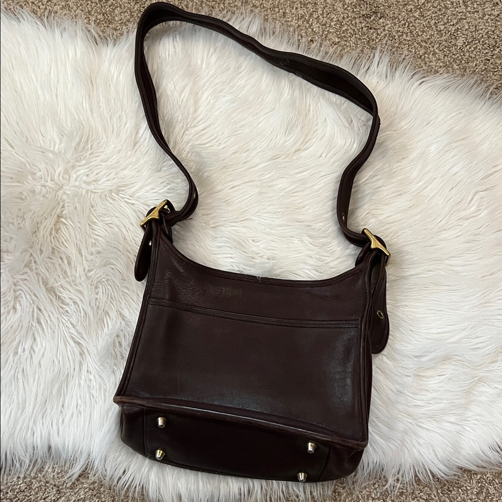 Coach brown leather shoulder bag with brass buckle details